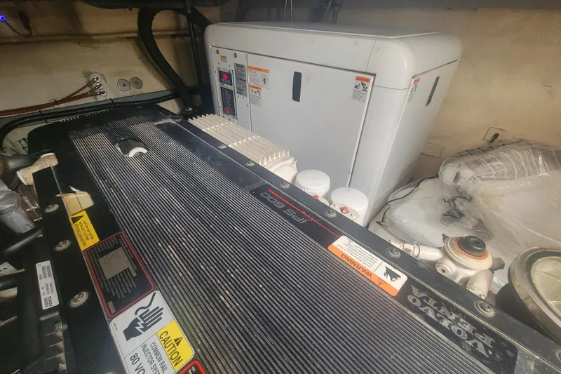 Slide: The Image of Engine room of 2012 Four Winns V435 boat, featuring Volvo Penta components and warning labels. - 82