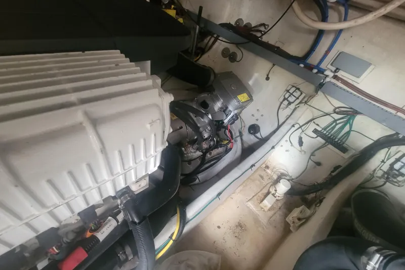 Slide: The Image of Engine room of a 2012 Four Winns V435 boat, showcasing mechanical components and wiring. - 83