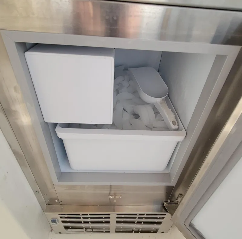 Slide: The Image of Ice maker on a 1996 Tiara Yachts 4000 Express, filled with ice and a scoop. - 45