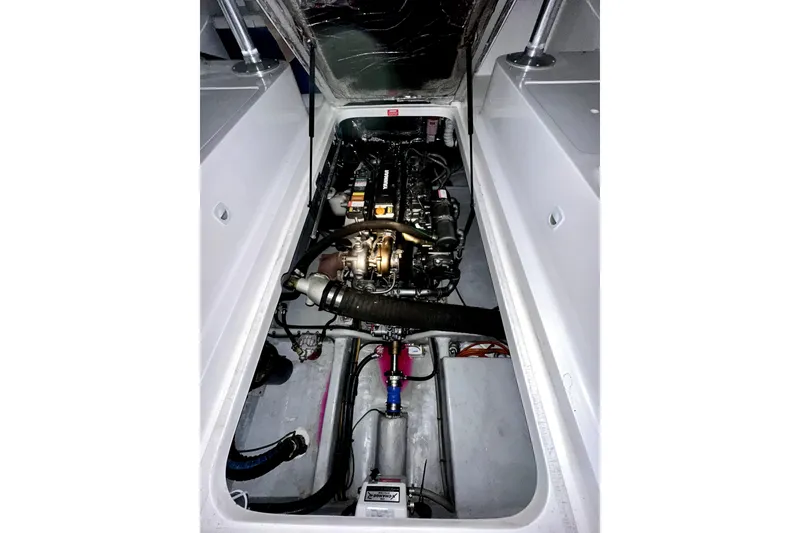 Slide: The Image of Engine compartment of a 2003 Mainship Pilot 30-II boat, showcasing mechanical components. - 13