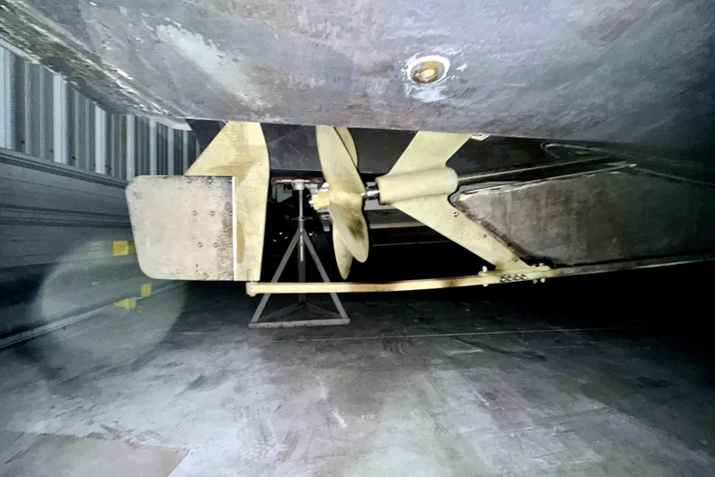 Slide: The Image of Underside view of 2003 Mainship Pilot 30-II boat propeller and rudder in storage. - 14