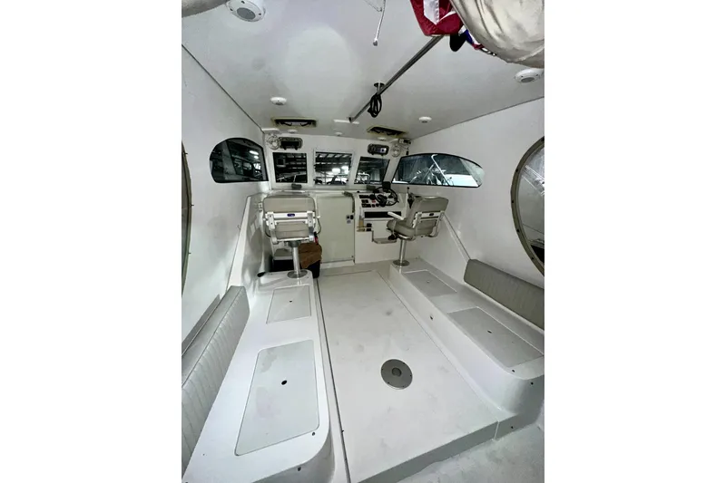 Slide: The Image of 2003 Mainship Pilot 30-II boat interior with helm, seating, and controls. - 4