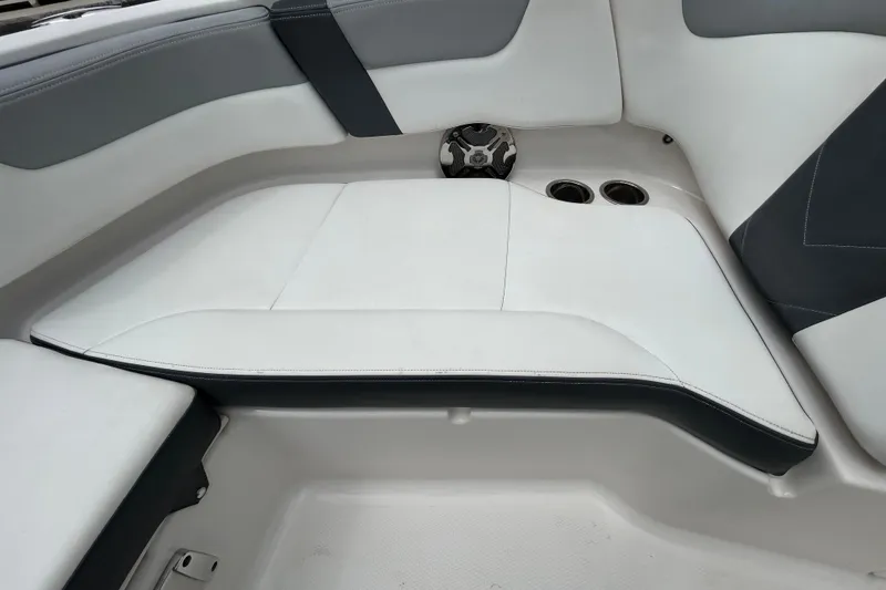 Slide: The Image of 2020 Chaparral 230 Suncoast boat interior with white and gray seating. - 100