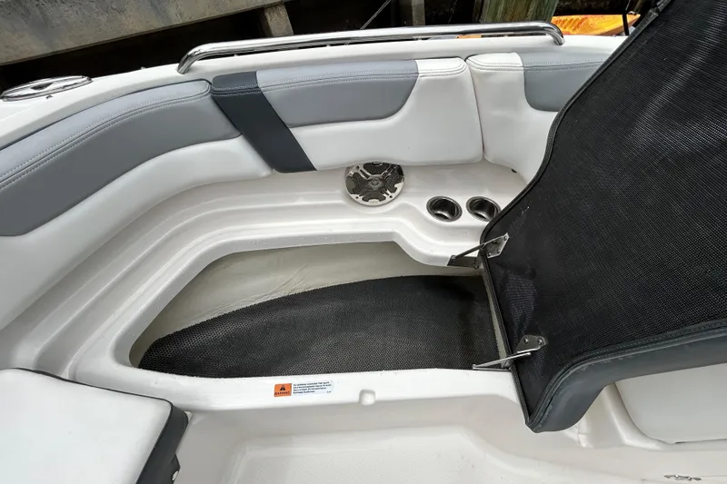 Slide: The Image of Interior view of a 2020 Chaparral 230 Suncoast boat, featuring seating and storage compartments. - 101