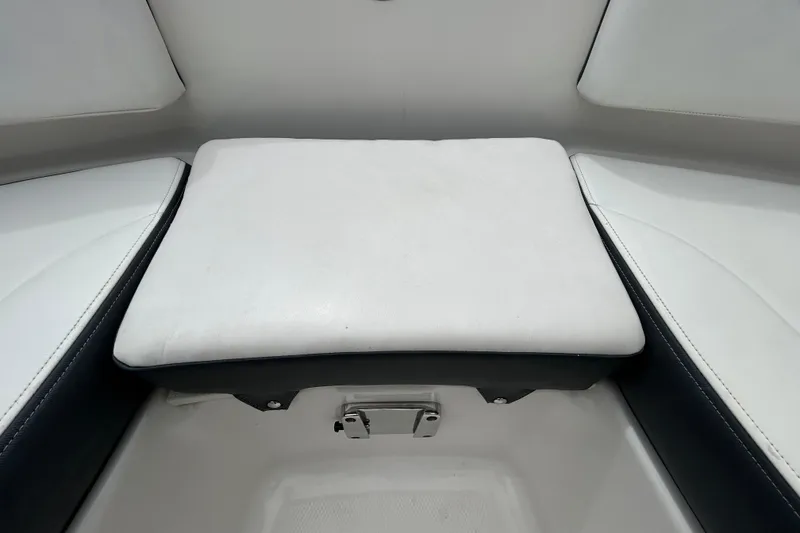 Slide: The Image of 2020 Chaparral 230 Suncoast boat interior with white and gray seating and cup holders. - 103