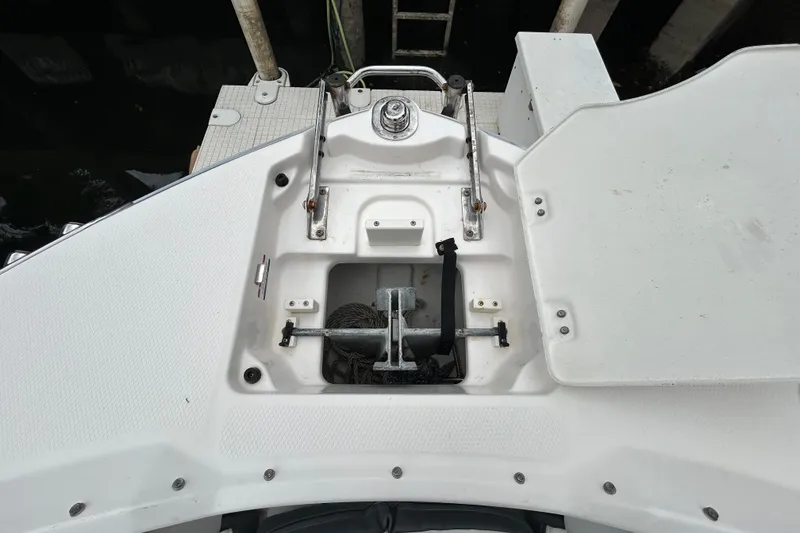 Slide: The Image of Storage compartment on 2020 Chaparral 230 Suncoast boat with black rope inside. - 108