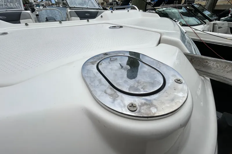 Slide: The Image of 2020 Chaparral 230 Suncoast boat anchor compartment with open hatch. - 111