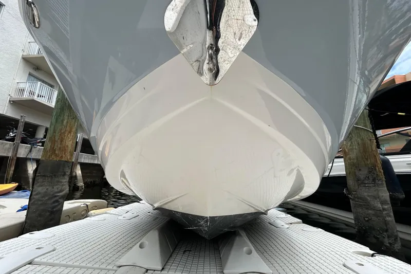 Slide: The Image of 2020 Chaparral 230 Suncoast boat hull on dock, showcasing sleek design and craftsmanship. - 14