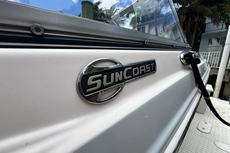 Slide: The Image of 2020 Chaparral 230 Suncoast boat side view with logo and docked rope. - 16