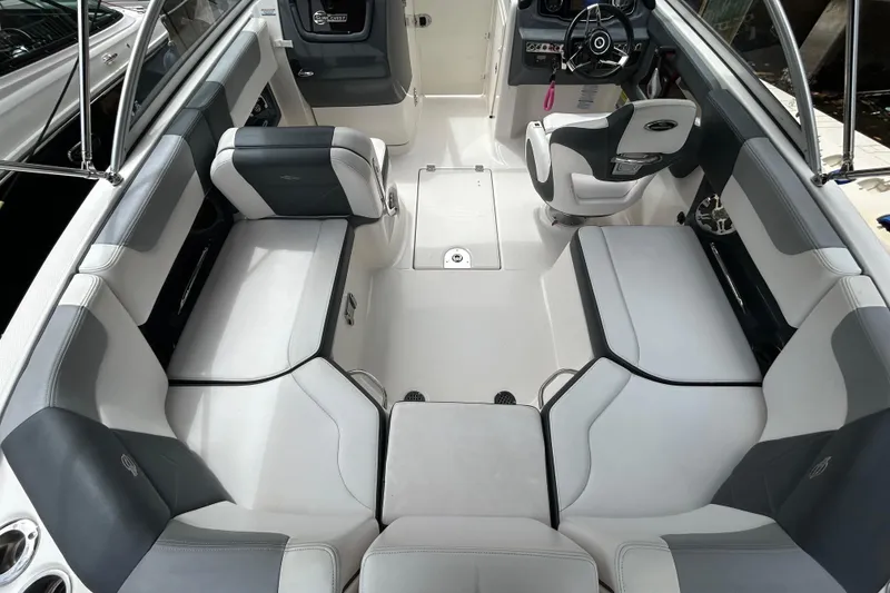 Slide: The Image of 2020 Chaparral 230 Suncoast boat interior with spacious seating and modern helm design. - 20