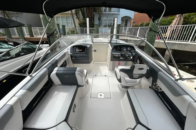 Slide: The Image of 2020 Chaparral 230 Suncoast boat interior with seating and steering wheel. - 21