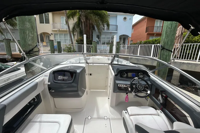 Slide: The Image of 2020 Chaparral 230 Suncoast boat interior with steering wheel and dashboard view. - 23