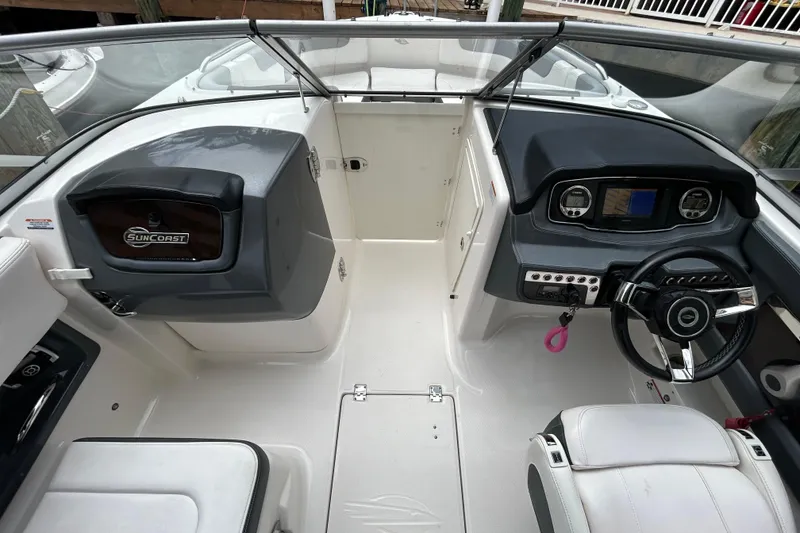 Slide: The Image of 2020 Chaparral 230 Suncoast boat interior with steering wheel and dashboard controls. - 24