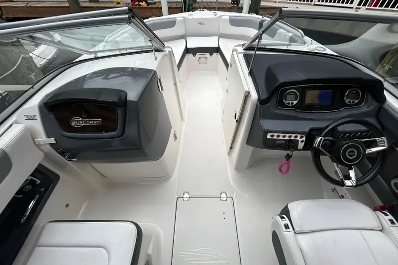 Slide: The Image of Interior view of 2020 Chaparral 230 Suncoast boat, featuring helm and seating area. - 25