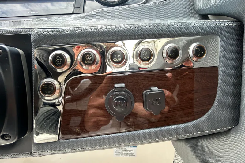 Slide: The Image of Control panel of a 2020 Chaparral 230 Suncoast boat with various switches and inputs. - 30