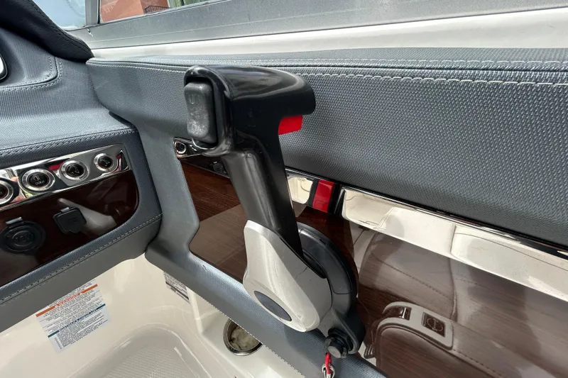 Slide: The Image of Interior view of 2020 Chaparral 230 Suncoast boat throttle control. - 31