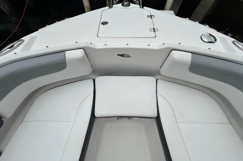 Slide: The Image of 2020 Chaparral 230 Suncoast boat interior with white cushioned seating. - 36
