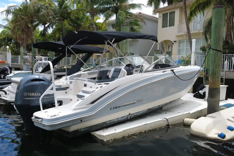 Slide: The Image of 2020 Chaparral 230 Suncoast boat docked, featuring Yamaha outboard motor, palm trees in background. - 4