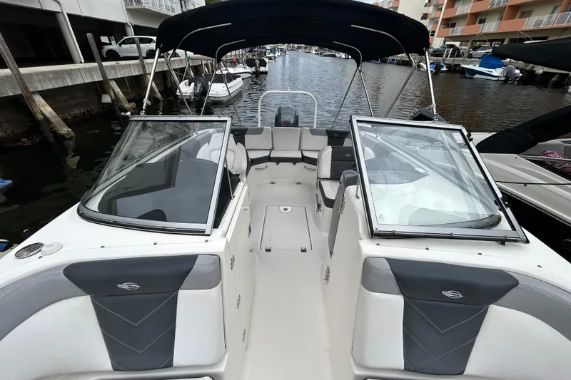Slide: The Image of 2020 Chaparral 230 Suncoast boat with open cockpit, docked in a marina. - 42