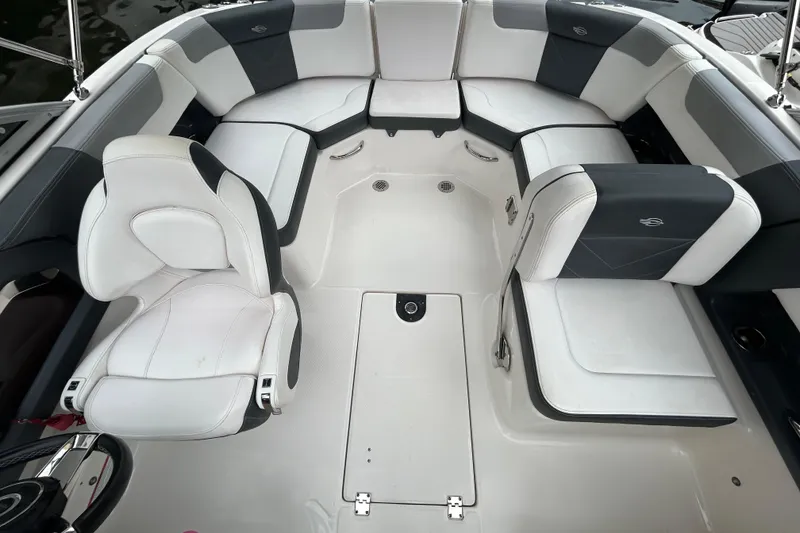 Slide: The Image of 2020 Chaparral 230 Suncoast boat interior with white and gray seating arrangement. - 46