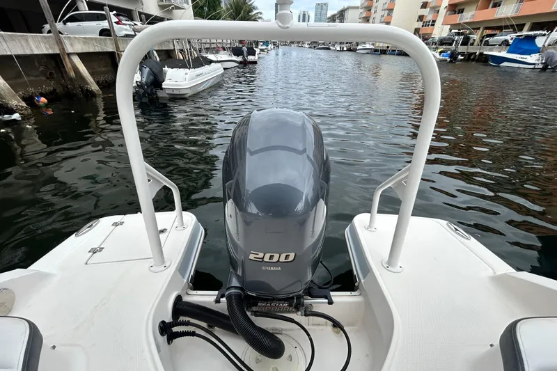 Slide: The Image of 2020 Chaparral 230 Suncoast boat with Yamaha 200 engine docked in a marina. - 51