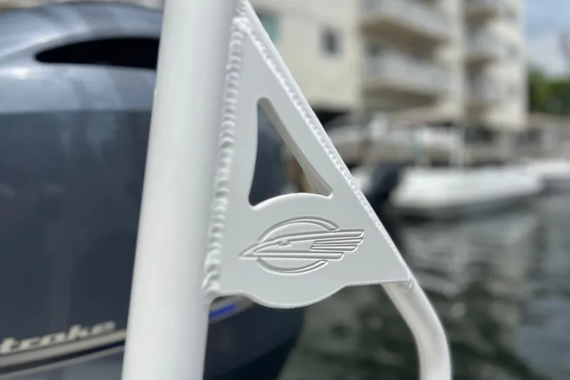 Slide: The Image of Close-up of Chaparral 230 Suncoast 2020 boat logo with blurred marina background. - 52