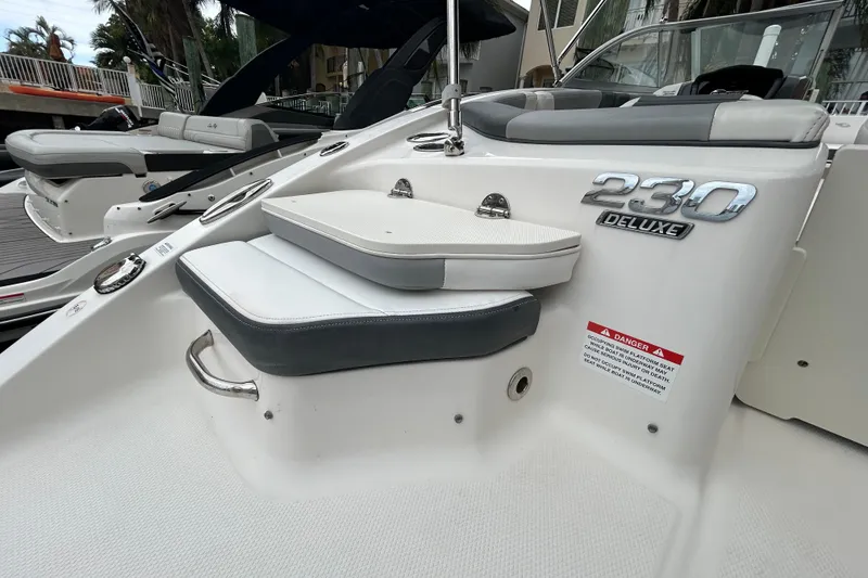 Slide: The Image of 2020 Chaparral 230 Suncoast boat interior with deluxe seating and safety warning. - 56