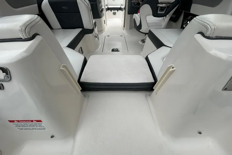 Slide: The Image of Interior view of 2020 Chaparral 230 Suncoast boat, featuring seating and cockpit area. - 61