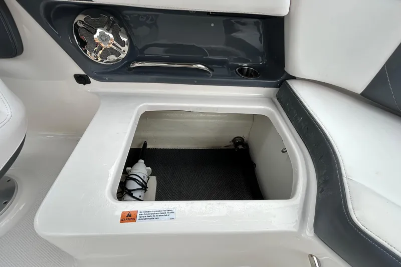 Slide: The Image of Storage compartment in 2020 Chaparral 230 Suncoast boat with speaker and cup holder. - 69