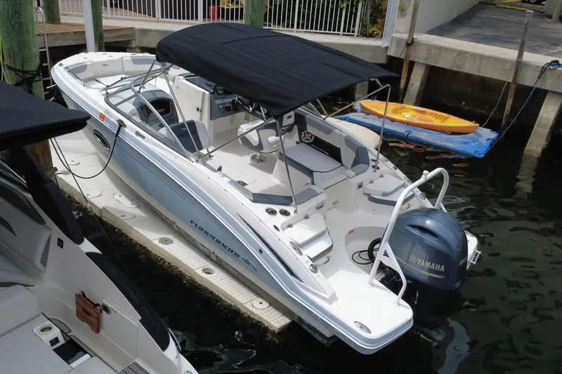 Slide: The Image of 2020 Chaparral 230 Suncoast boat docked with Yamaha engine and black canopy. - 7