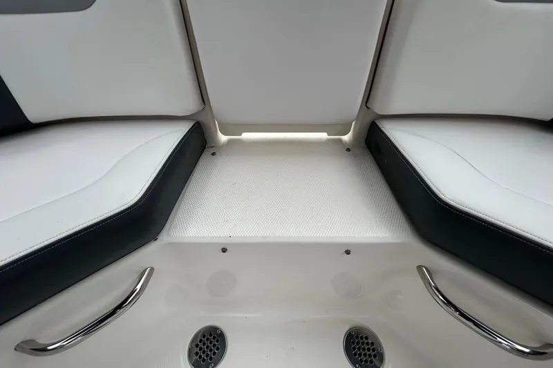 Slide: The Image of Interior seating of 2020 Chaparral 230 Suncoast boat with white and black upholstery. - 75