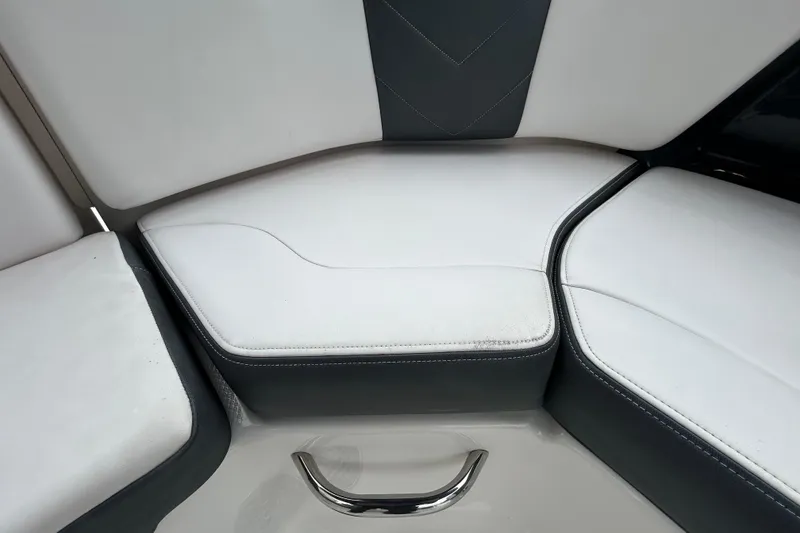 Slide: The Image of 2020 Chaparral 230 Suncoast boat interior seating with white and gray upholstery. - 76