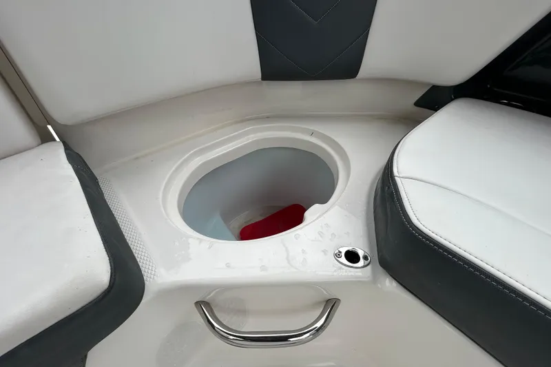 Slide: The Image of 2020 Chaparral 230 Suncoast boat interior with storage compartment and seating. - 77