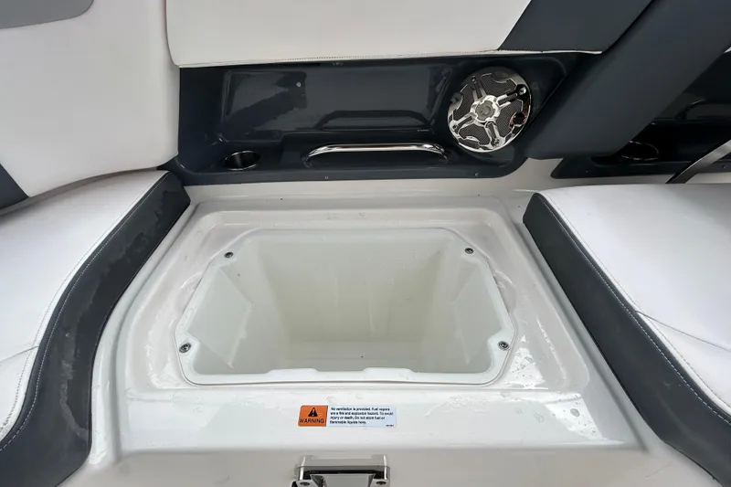 Slide: The Image of 2020 Chaparral 230 Suncoast boat interior with storage compartment and speaker. - 80
