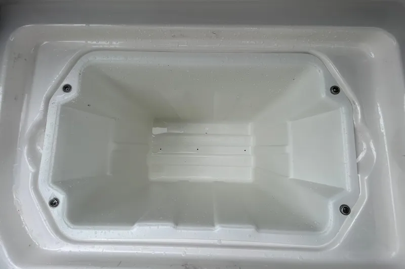 Slide: The Image of White storage compartment in 2020 Chaparral 230 Suncoast boat, featuring a clean interior. - 81