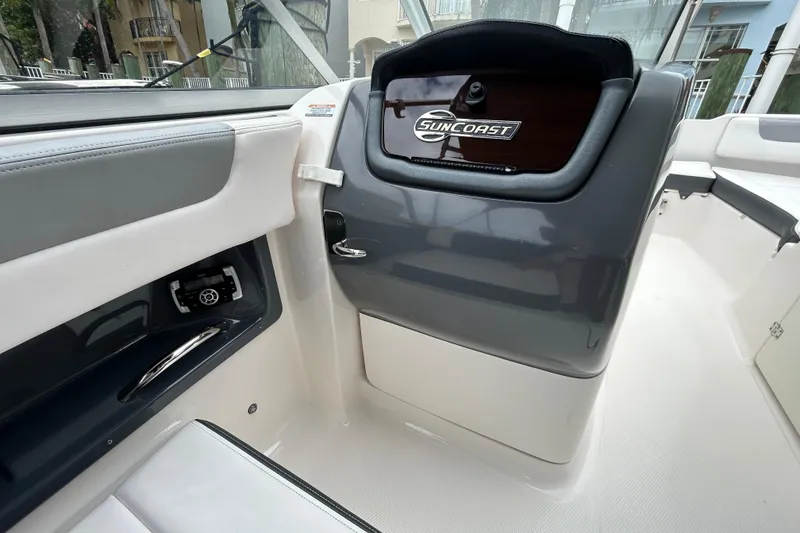 Slide: The Image of 2020 Chaparral 230 Suncoast boat interior with sleek dashboard and seating. - 88