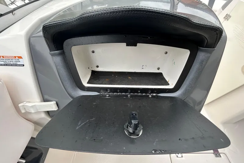 Slide: The Image of Open storage compartment on a 2020 Chaparral 230 Suncoast boat. - 90