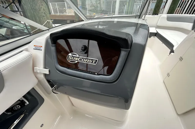 Slide: The Image of 2020 Chaparral 230 Suncoast boat dashboard with Suncoast logo and seating area. - 92