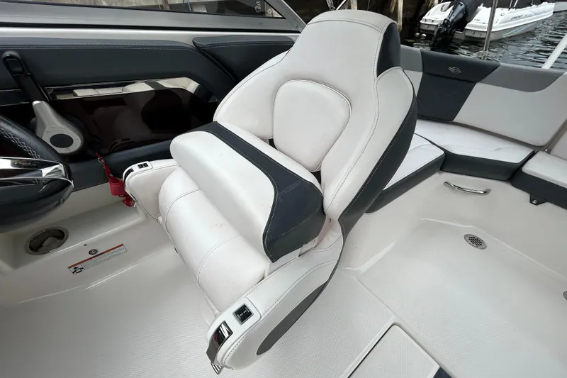 Slide: The Image of 2020 Chaparral 230 Suncoast boat interior with white and black seating. - 96