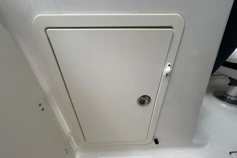 Slide: The Image of Storage compartment on a 2020 Chaparral 230 Suncoast boat interior. - 97