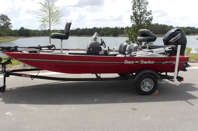 The Image of 2024 Tracker Bass Tracker Classic XL boat on trailer by a lake. - 0
