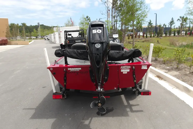 Slide: The Image of 2024 Tracker Bass Tracker Classic XL boat with 50 HP motor, parked outdoors. - 6