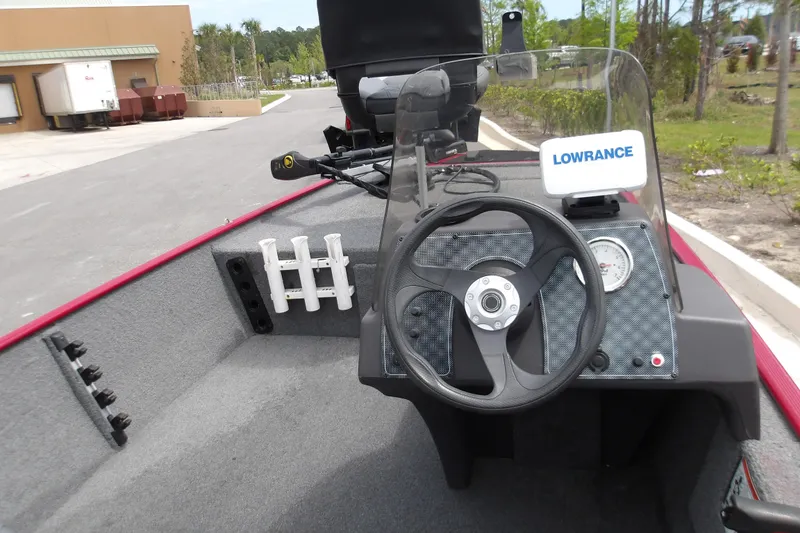 Slide: The Image of 2024 Tracker Bass Tracker Classic XL boat dashboard with steering wheel and Lowrance fish finder. - 9