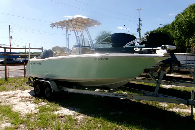 The Image of 2020 Key West 203 FS boat on trailer, parked outdoors under clear sky. - 1