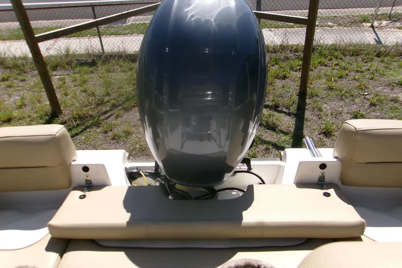 Slide: The Image of 2020 Key West 203 FS boat with beige seating and powerful outboard motor. - 14