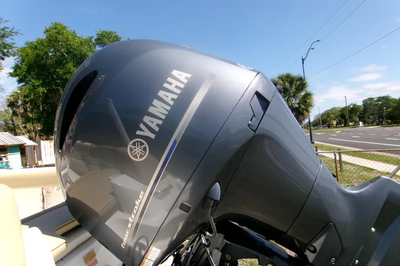 Slide: The Image of Yamaha outboard motor on 2020 Key West 203 FS boat, parked near a road. - 4