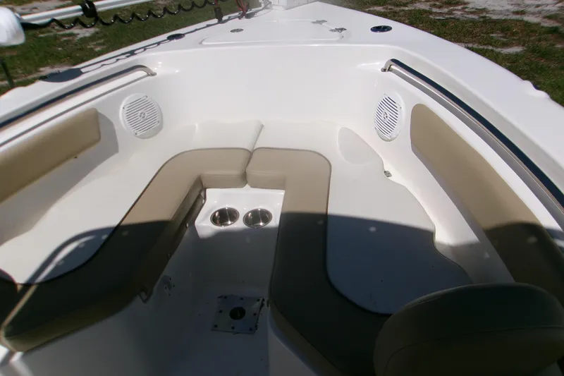 Slide: The Image of 2020 Key West 203 FS boat interior with cushioned seating and cup holders. - 9