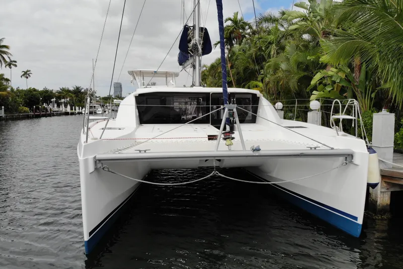 Slide: The Image of 2018 Leopard 40 catamaran docked in a lush, tropical marina setting. - 23