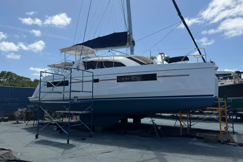 Slide: The Image of 2018 Leopard 40 catamaran on dry dock with scaffolding under a clear blue sky. - 29