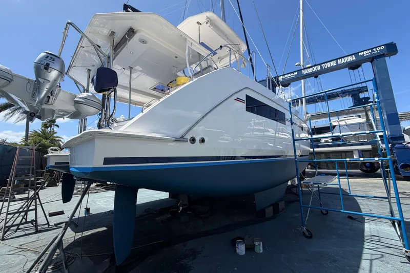 Slide: The Image of 2018 Leopard 40 catamaran in marina, elevated for maintenance under clear blue sky. - 30